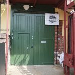 A large green door with the sign Ipswich Maker Space