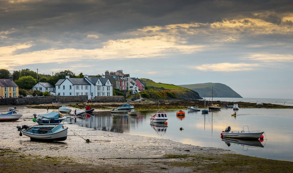 A coastal scene with mud flats and small boats