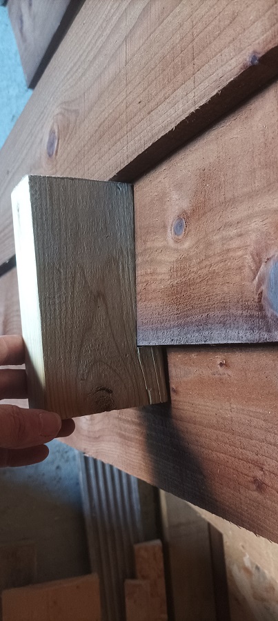 A wooden block with a cutout used to ensure the plank spacing was consistent
